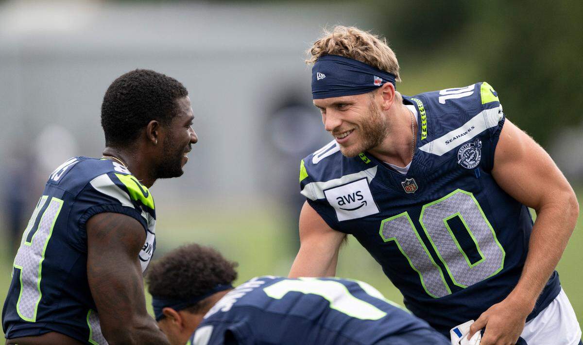 Seattle Seahawks wide receiver Steven Sims (84) and wide receiver Cooper Kupp (10) talk during training camp at Virginia Mason Athletic Center on Friday, July 25, 2025, in Renton, Wash.