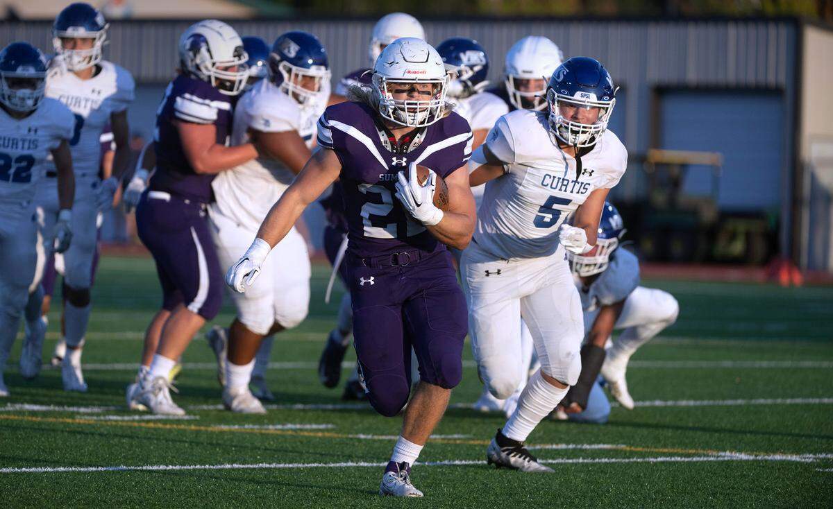 Sumner running back Matthew Spurbeck breaks loose in front of Curtis defender Micah Yanos (5) during Friday night’s football game at Sunset Chevy Stadium in Sumner, Washington, on Sept. 8, 2023. Curtis won the game, 38-33.