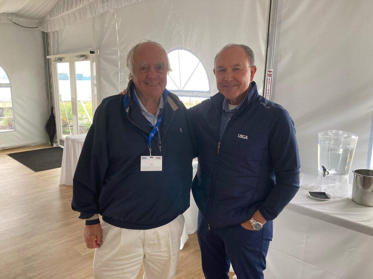 Robert Trent Jones Jr. (left), course designer for Chambers Bay, with United States Golf Association Senior Managing Director for Championships John Bodenhamer (right) on the deck outside the link-course clubhouse in University Place, Washington, on May 24, 2021.