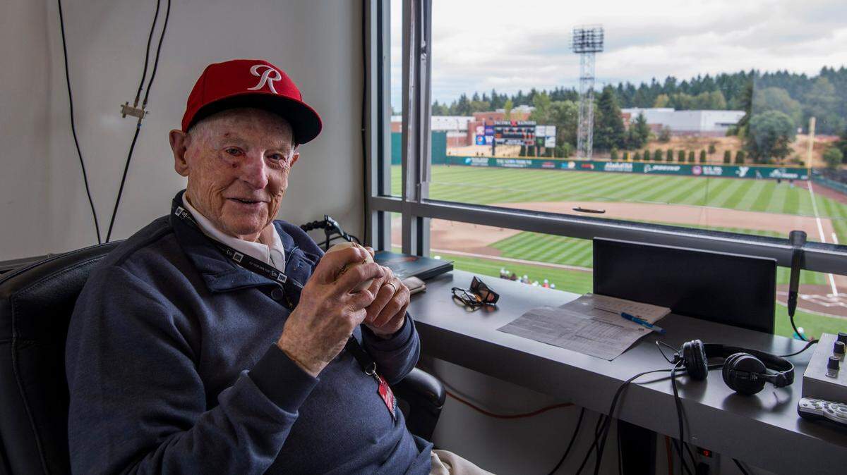 Bob Robertson, a longtime announcer for the Tacoma Rainiers baseball club at his spot in the broadcast booth which is now named after him in Cheney Stadium, August 25, 2018.  