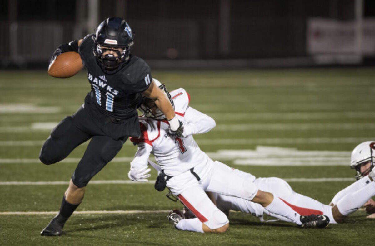 Hockinson’s Sawyer Racanelli (11) breaks away from Steilacoom’s Jayden Coalsen (1) during the 2A state football quarterfinals at Doc Harris Stadium in Camas on Friday, Nov. 16, 2018. Hockinson defeated Steilacoom 35-28.