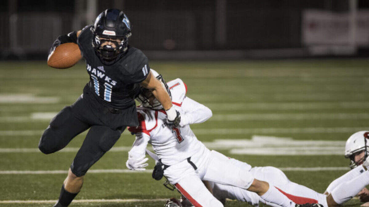 Hockinson’s Sawyer Racanelli (11) breaks away from Steilacoom’s Jayden Coalsen (1) during the 2A state football quarterfinals at Doc Harris Stadium in Camas on Friday, Nov. 16, 2018. Hockinson defeated Steilacoom 35-28.
