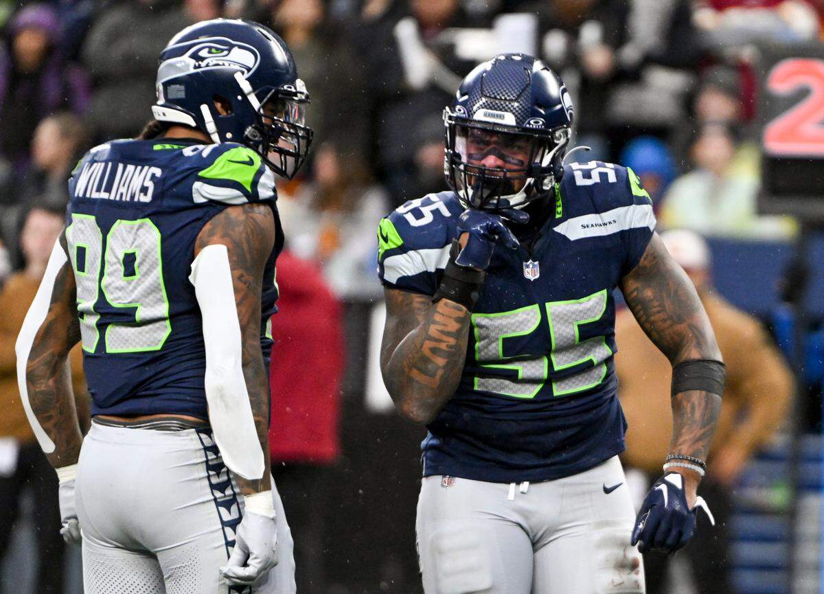 Seattle Seahawks defensive end Dre’Mont Jones (55) reacts to a hit on Washington Commanders quarterback Sam Howell (14) during the third quarter of the game at Lumen Field, on Sunday, Nov. 12, 2023, in Seattle, Wash.