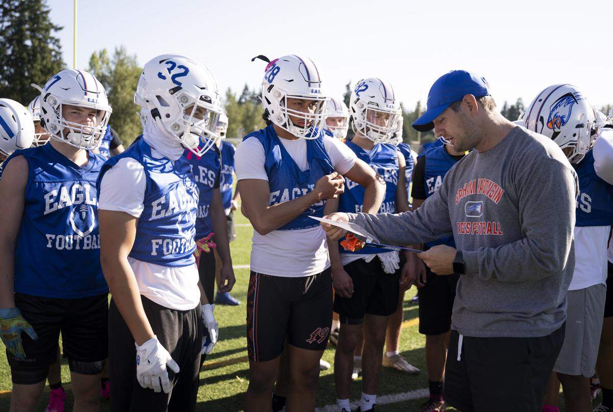 Head coach Jeff Logan gives out assignments during a football practice at Graham-Kapowsin High School on Friday, Aug. 22, 2025, in Graham, Wash.