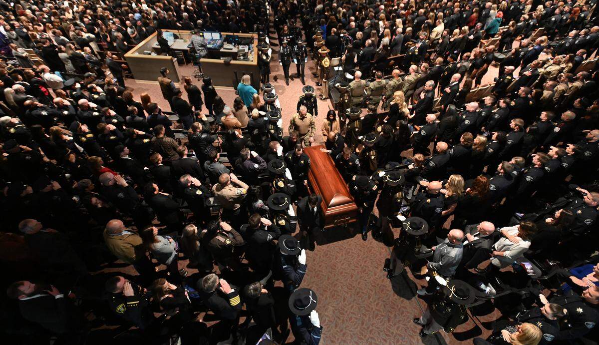Hundreds of fellow law enforcement officers and supporters surround Pierce County sheriff’s deputy Dom Calata as he is taken out from the Church For All Nations in Parkland at the conclusion of his celebration of life on Friday, March 25, 2022.