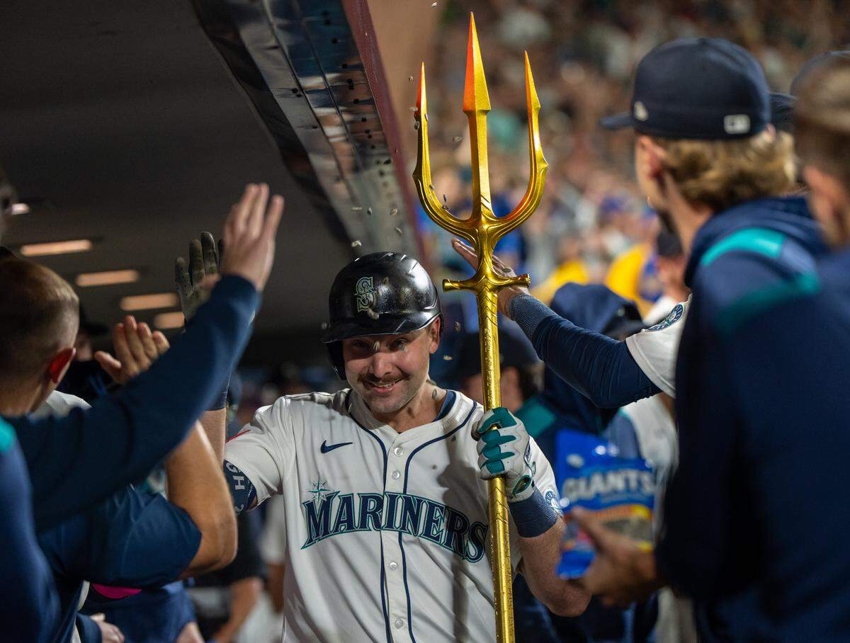Sep 24, 2025; Seattle, Washington, USA; Seattle Mariners catcher Cal Raleigh (29) celebrates in the dugout after hitting a solo home run during the eighth inning against the Colorado Rockies at T-Mobile Park. Mandatory Credit: Stephen Brashear-Imagn Images