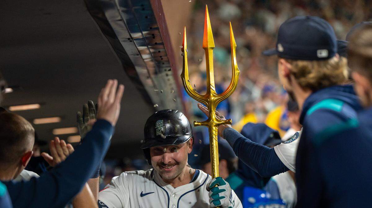 Sep 24, 2025; Seattle, Washington, USA; Seattle Mariners catcher Cal Raleigh (29) celebrates in the dugout after hitting a solo home run during the eighth inning against the Colorado Rockies at T-Mobile Park. Mandatory Credit: Stephen Brashear-Imagn Images