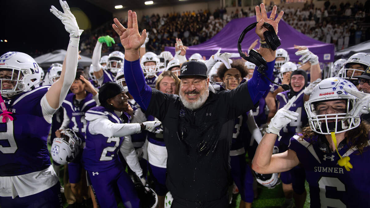 Sumner head coach Keith Ross celebrates with the Spartans as time expires in Friday night’s football game against the Graham Kapowsin Eagles at Sunset Chev Stadium in Sumner, Washington, on Nov. 1, 2024. Sumner won the game, 23-11.