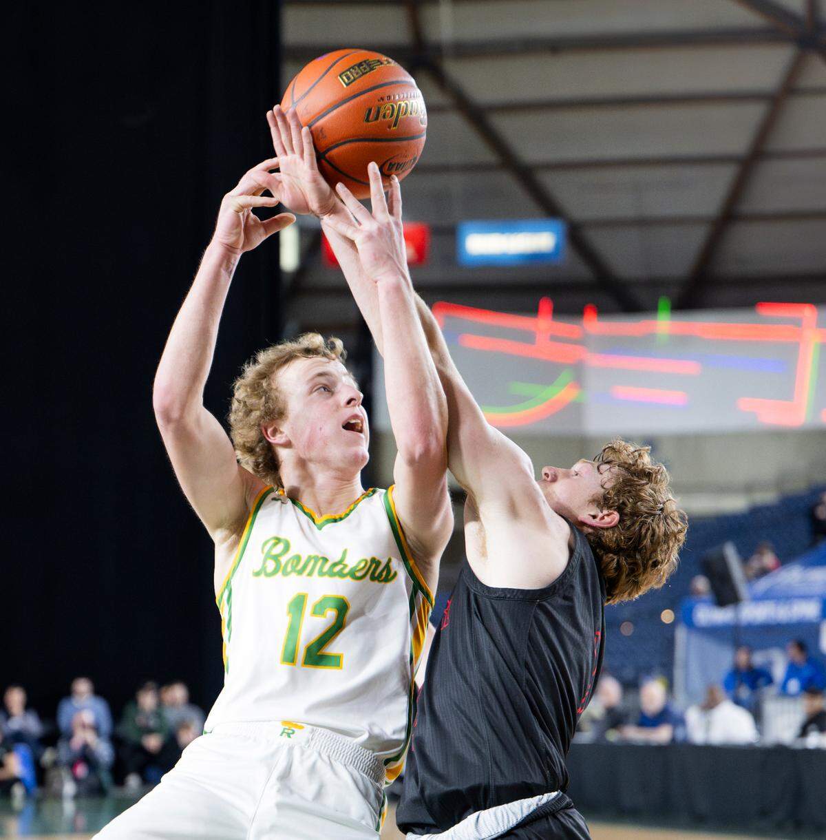 Richland’s Joshua Woodard (12) and Mount Si’s Blake Forrest (2) tangle up as Woodard goes to the net during the first half of the Class 4A state championship game at the Tacoma Dome earlier this month.
