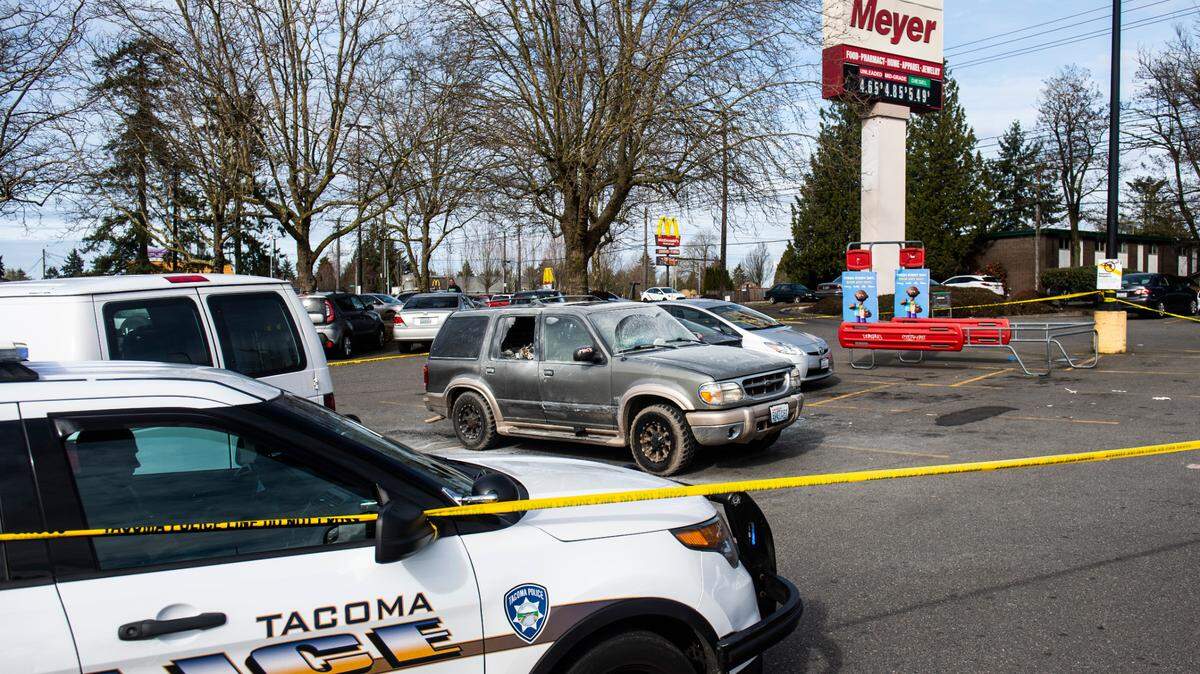 The remains of a car that was found engulfed in flames in a Fred Meyer parking lot sits on the 7200 block of Pacific Avenue in Tacoma, Wash. on Friday, March 25, 2022. A man was pulled from the burning vehicle by people in the parking lot and pronounced dead at the scene by officers.