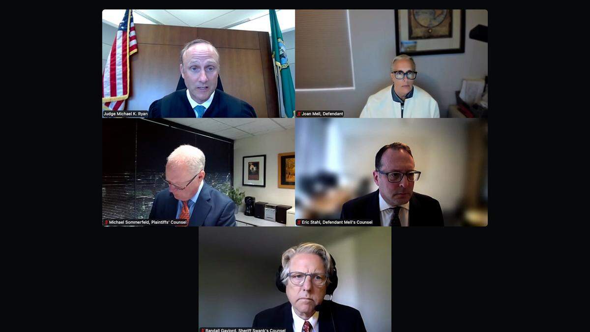 Clockwise from top left, King County Superior Court Judge Michael Ryan, attorney Joan Mell; her attorney, Eric Stahl; special deputy prosecuting attorney for Pierce County Sheriff Keith Swank, Randall Gaylord ;and deputy prosecuting attorney for Prosecutor Mary Robnett, Michael Sommerfeld, appear in court April 24, 2026, via Zoom for a hearing in Robnett’s lawsuit against Mell.