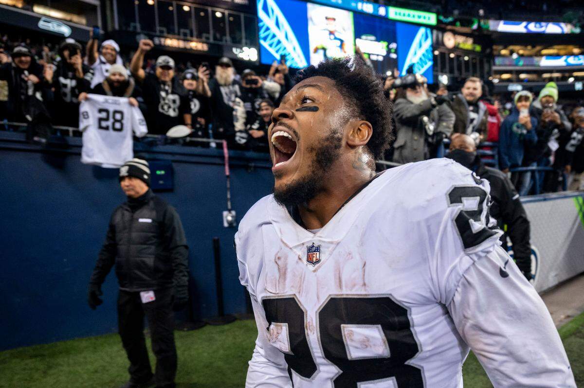 Las Vegas Raiders running back Josh Jacobs (28) celebrates as he runs into the locker room after scoring the game-winning touchdown on an 86-yard run in overtime of an NFL game against the Seattle Seahawks on Sunday, Nov. 27, 2022, at Lumen Field in Seattle.