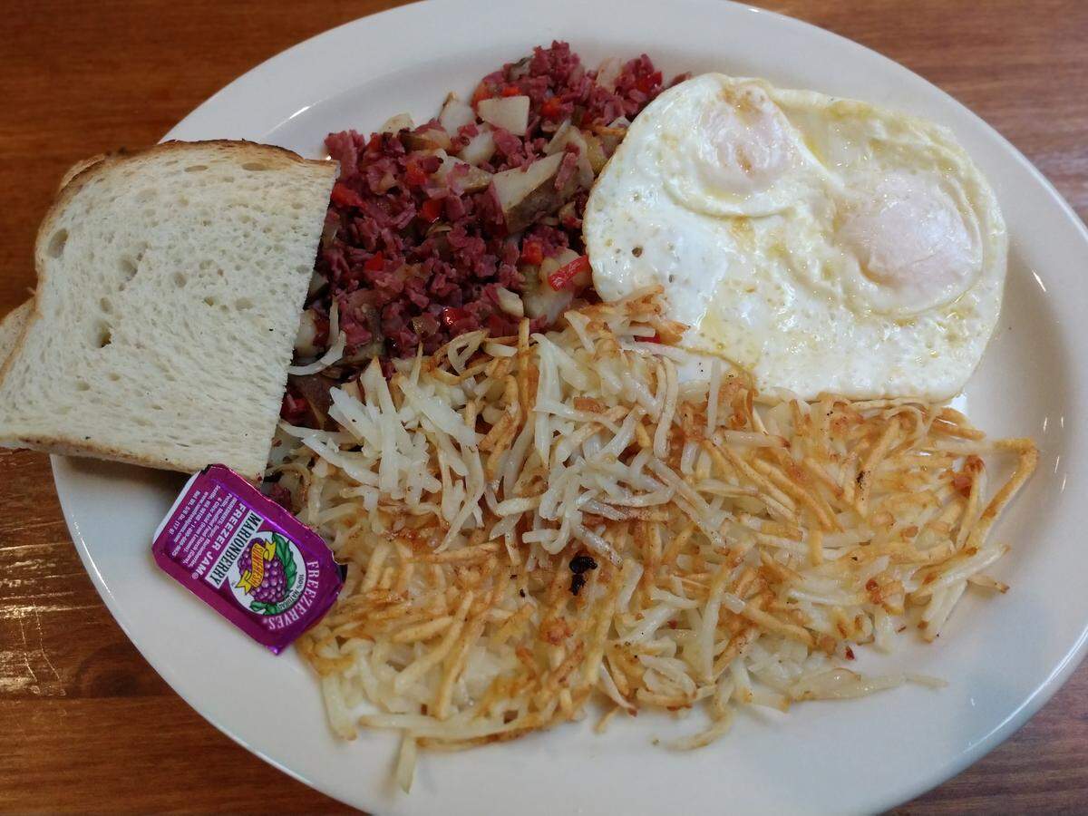 Corned beef hash, hash browns, toast and jam from West Pioneer Grill.