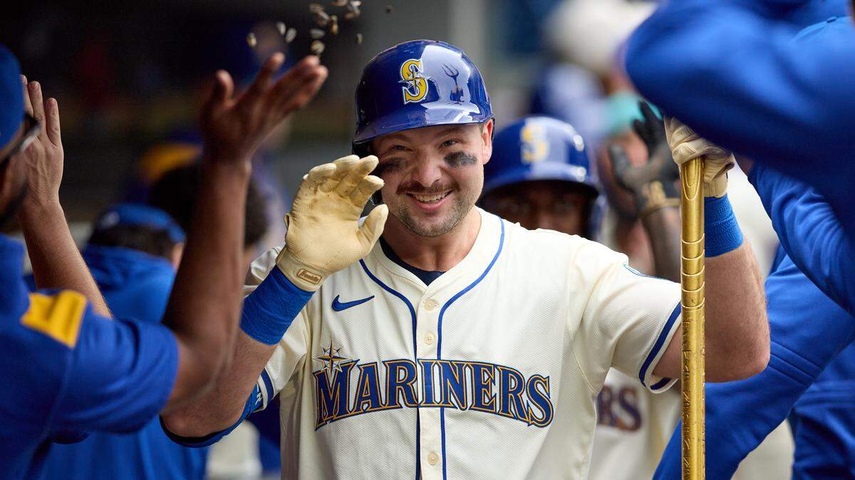 Sep 14, 2025; Seattle, Washington, USA; Seattle Mariners catcher Cal Raleigh (29) is greeted in the dugout after hitting a two-run home against the Los Angeles Angels in the first inning at T-Mobile Park. Mandatory Credit: John Froschauer-Imagn Images