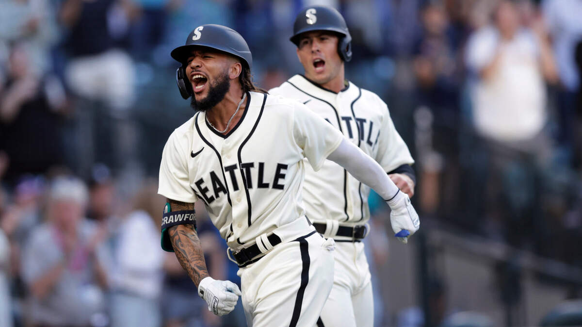 Seattle Mariners’ J.P. Crawford celebrates at home with Dylan Moore behind, after hitting a grand slam off Tampa Bay Rays starting pitcher Josh Fleming during the second inning of a baseball game Saturday, June 19, 2021, in Seattle. (AP Photo/John Froschauer)