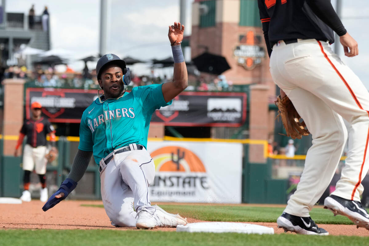 Seattle Mariners’ Ryan Bliss steals third base against the San Francisco Giants during the fourth inning of a spring training baseball game Tuesday, Feb. 27, 2024, in Scottsdale, Ariz. (AP Photo/Ross D. Franklin)