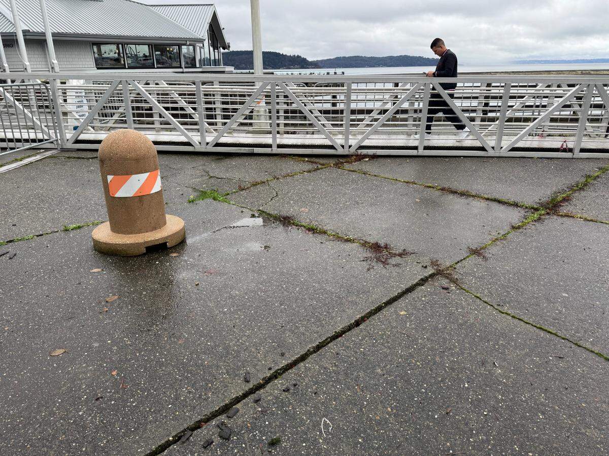A visitor to Anthony’s and Point Defiance uses a gangway Friday afternoon to bypass a cordoned off sidewalk. Dec. 27, 2024.