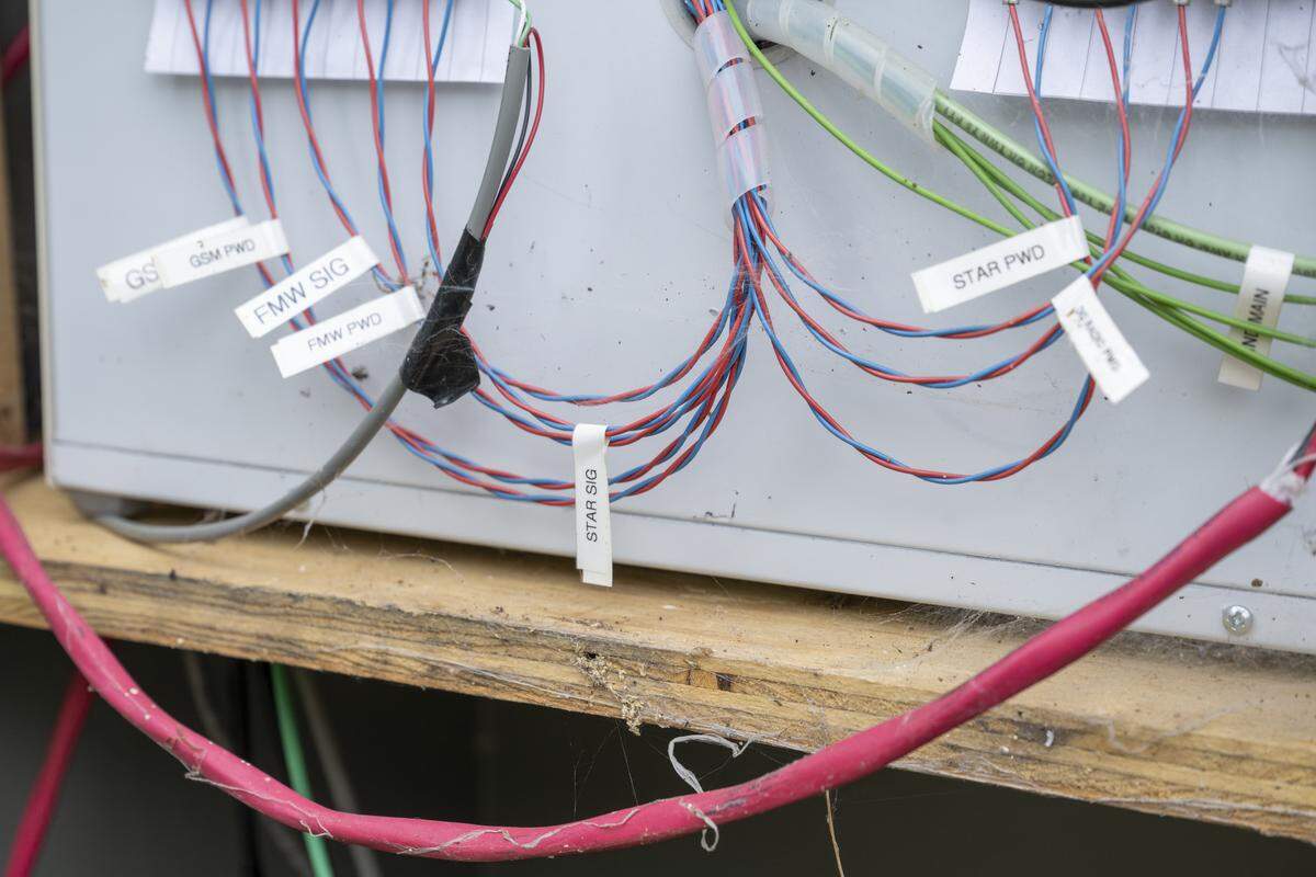 Wires hang from a device used to digitize information from STAR, one of three main seismic stations up high on Mount Rainier, on Thursday, Sept. 11, 2025, within a cabinet on a farm in Graham. The station, called Garrison Hill, is unique in that it not only records nearby earthquake data but also transmits data it receives by signal to PNSN’s server room at the University of Washington.