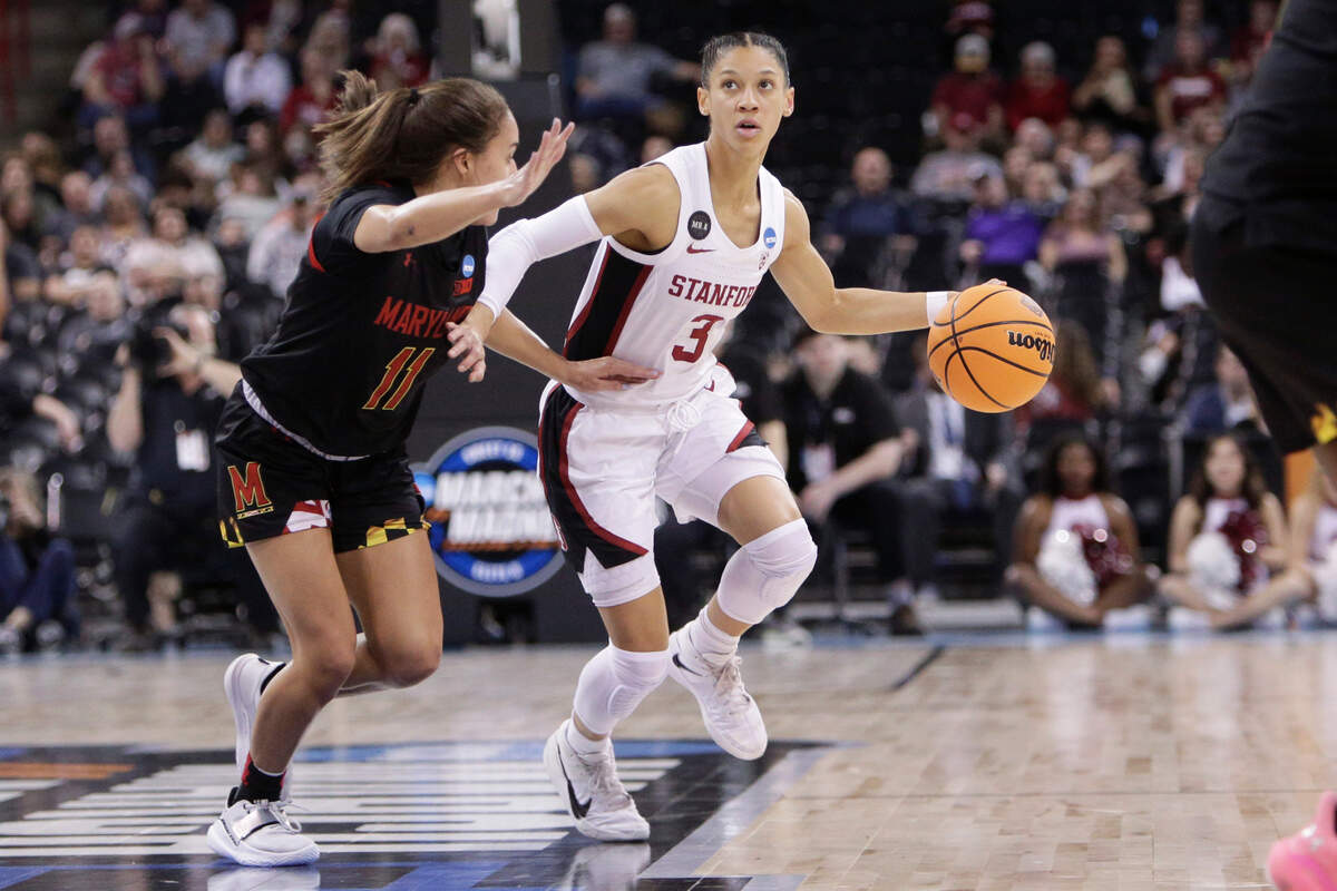 Stanford guard Anna Wilson (3) fends off Maryland guard Katie Benzan (11) during the first half of a college basketball game in the Sweet 16 round of the NCAA tournament, Friday, March 25, 2022, in Spokane, Wash. (AP Photo/Young Kwak)