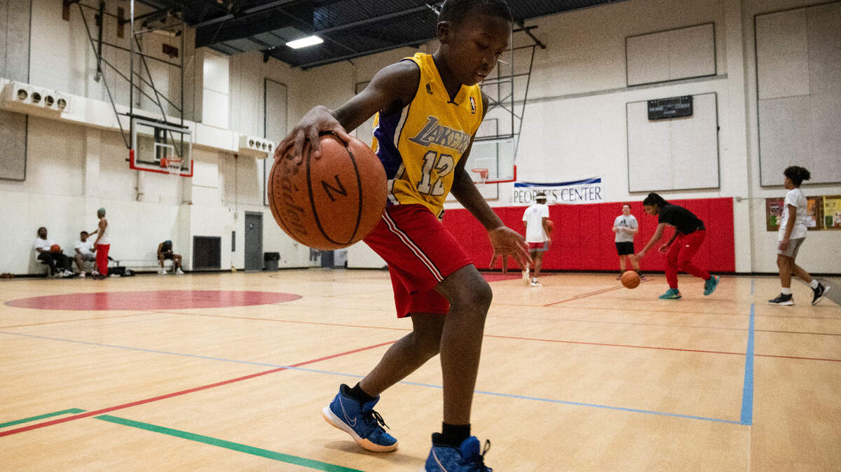 Osei Trahan-Castillo, 8, practices basketball skills at People’s Community Center in Tacoma on Monday, March 14, 2022. He comes every week, Monday through Thursday, to practice for a few hours.