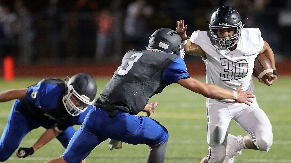 Central Kitsap High School running back Alex Refilong carries the ball in a football game against Olympic on Friday, Aug. 31, 2018 in Bremerton.