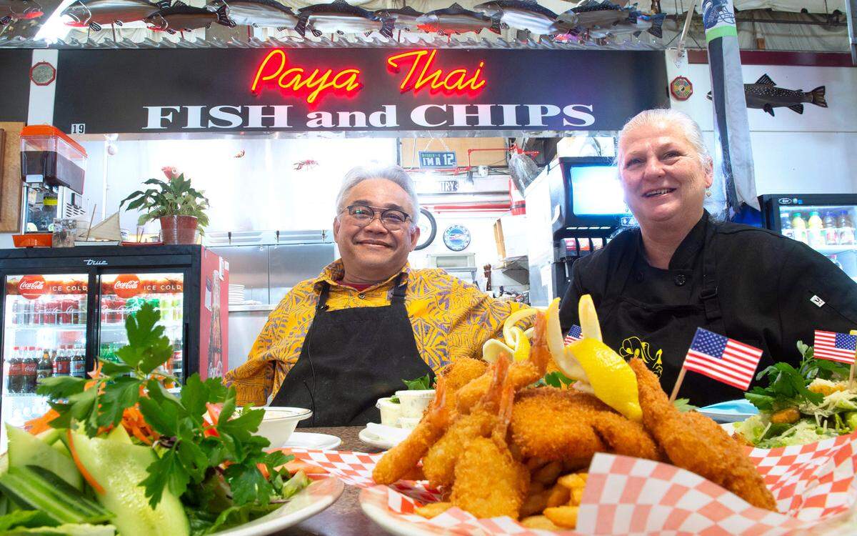 Chayan and Teresa Samalee show off the artistic garden salad and the top-selling Special Fish and Seafood plate at their Paya Thai Fish & Chips restaurant in the Freighthouse Square in Tacoma, Washington, on Thursday, March 11, 2021.