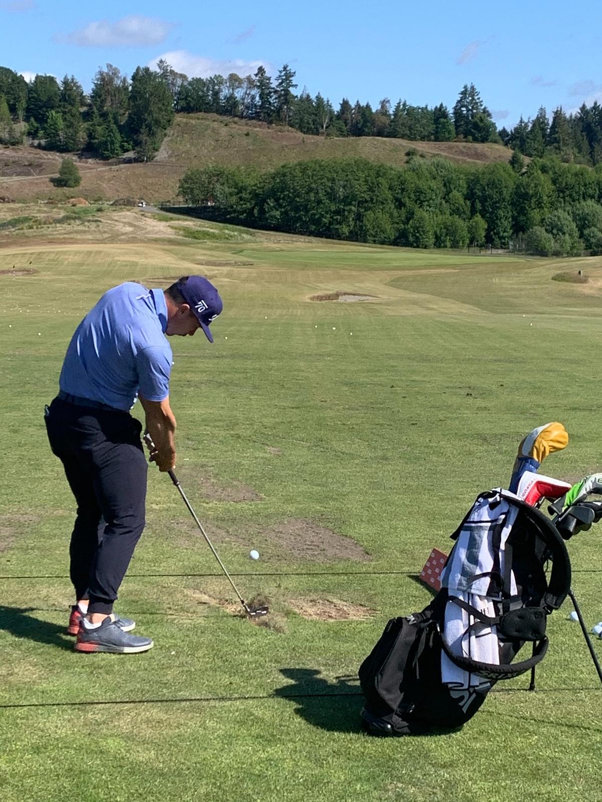 Danny Woodhead with another iron shot on the practice range at Chambers Bay for the 2021 U.S. Amateur Four-Ball Championship.