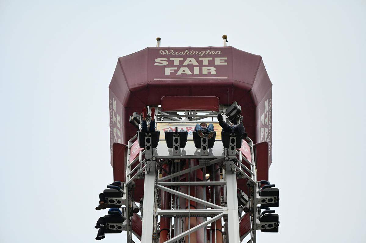 Members of the media ride the extreme scream at the Washington State Fair, Thursday, Aug. 31, 2023, Puyallup, Wash.