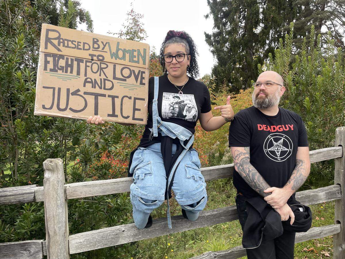 Tacoma residents Axaria O. and Andrew C. showed up to the No Kings protest by Point Defiance on Oct. 18, 2025 to stand up for women’s rights, LGBTQ+ rights, immigrant rights and other moves by the Trump administration. The couple declined to share their last names out of concern of their personal safety.