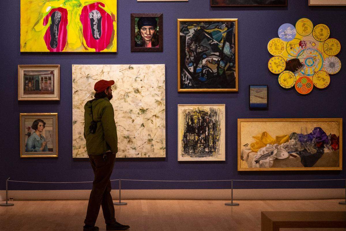 Nick Cuny, of Tacoma, looks at a wall of paintings at the Painting Deconstructed: Selections from the Northwest Collection in the Tacoma Art Museum on Dec. 16, 2022.