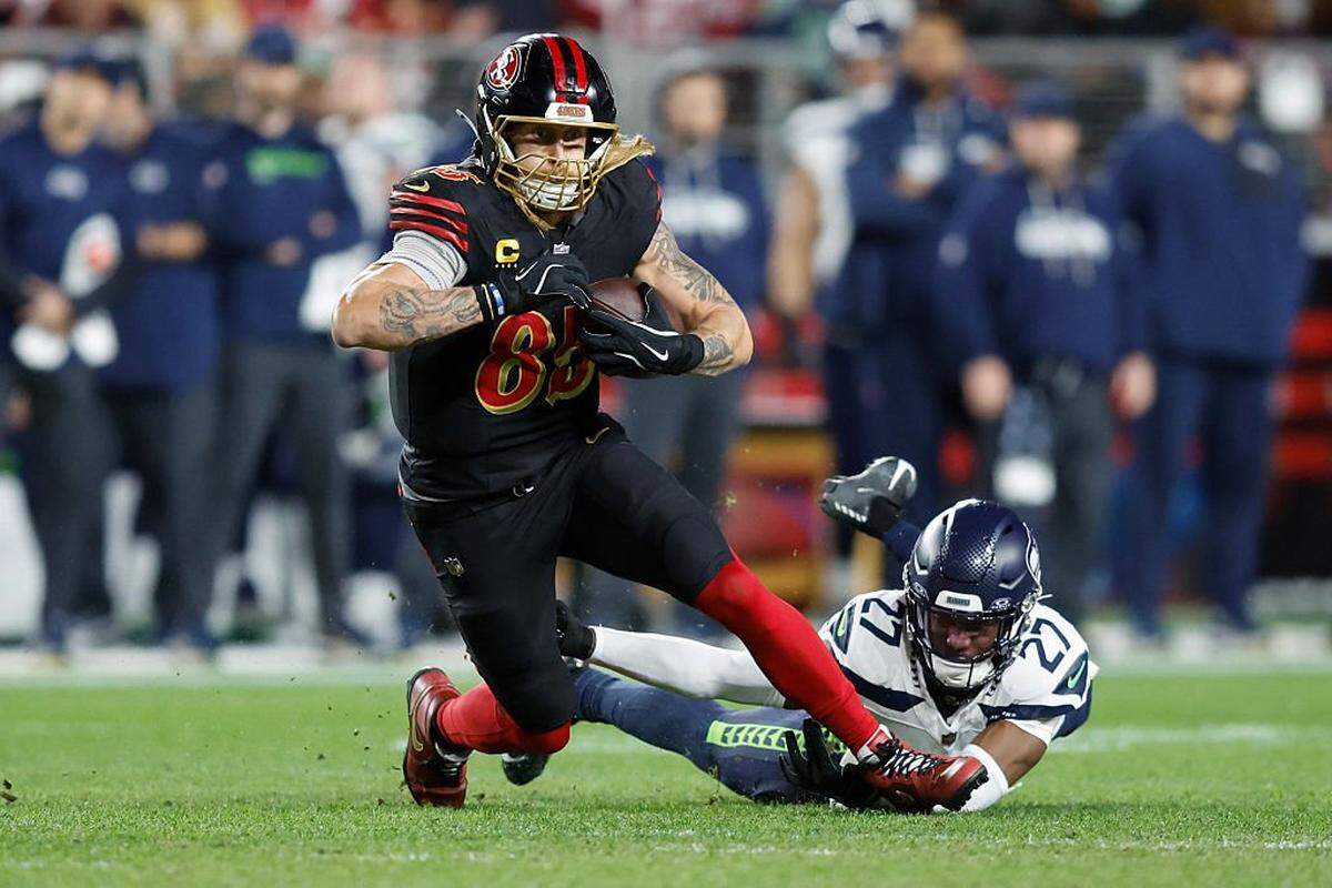 SANTA CLARA, CALIFORNIA - JANUARY 03: George Kittle #85 of the San Francisco 49ers breaks a tackle from Riq Woolen #27 of the Seattle Seahawks during the second quarter of a game at Levi's Stadium on January 03, 2026 in Santa Clara, California. (Photo by Lachlan Cunningham/Getty Images)