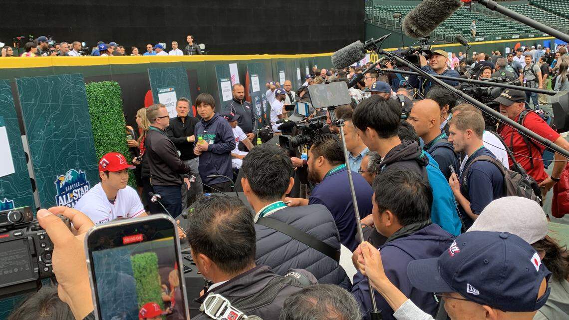 A criush of reporters and cameras surround Angels slugger and pitcher Shohei Otani on the warning track of T-Mobile Park on July 10, 2023, workout day before the 93rd All-Star Game in Seattle July 11, 2023.