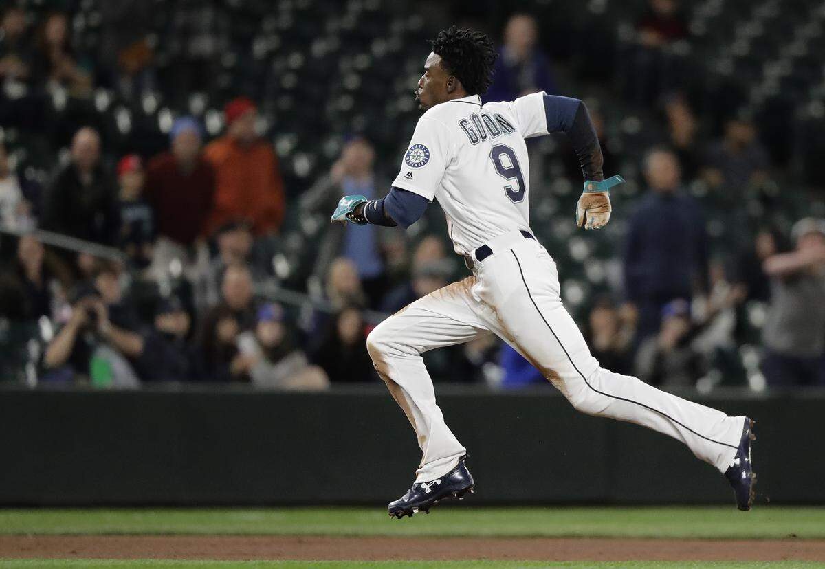 Seattle Mariners' Dee Gordon runs to third base after a throwing error charged to Oakland Athletics catcher Jonathan Lucroy as Gordon was stealing second base during the seventh inning of a baseball game Thursday, May 3, 2018, in Seattle. (AP Photo/Ted S. Warren)