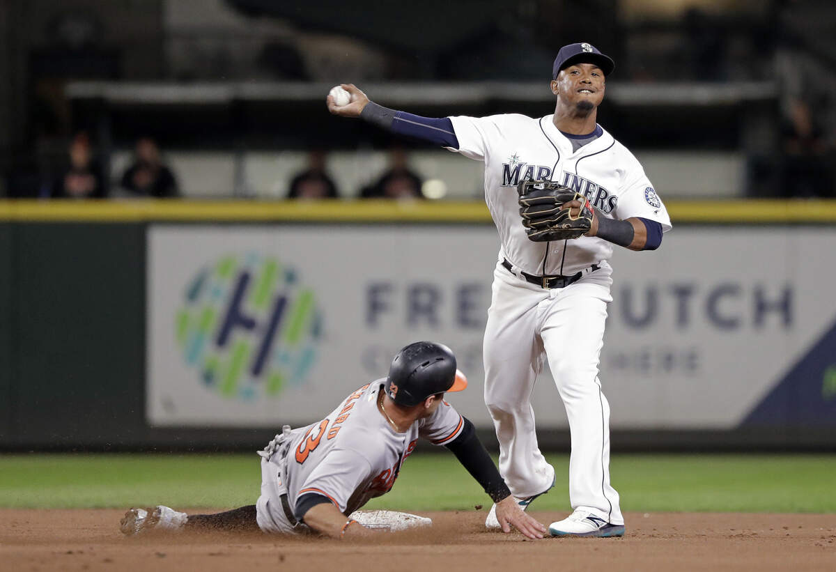 Seattle Mariners shortstop Jean Segura, right, throws to first base after forcing out Baltimore Orioles’ Joey Rickard at second base in the eighth inning of a baseball game Monday, Sept. 3, 2018, in Seattle. Segura completed the double play at first, throwing out Orioles’ Caleb Joseph. (AP Photo/Elaine Thompson)