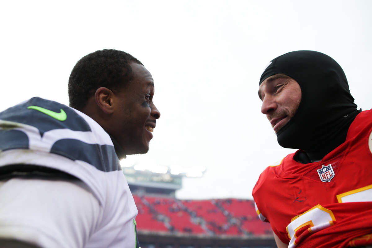 Seattle Seahawks quarterback Geno Smith (7) and Kansas City Chiefs tight end Travis Kelce (87) talk after the game on Saturday, Dec. 24, 2022, in Kansas City, MO.