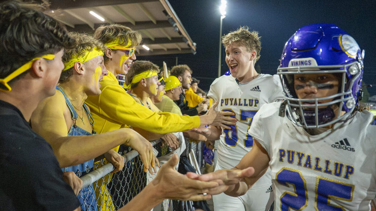 Puyallup students congratulate players on their win over Emerald Ridge on Friday, Sept. 26, 2025, in Puyallup, Wash.