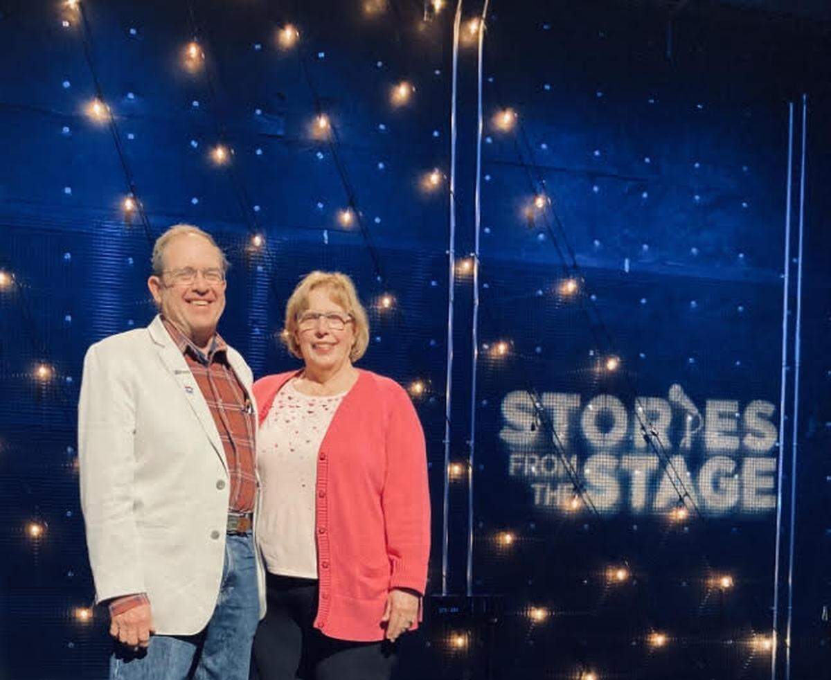 Gig Harbor couple Gary and Zoey Dering pose on stage at the filming of an episode of “Stories from the Stage” in Boston.