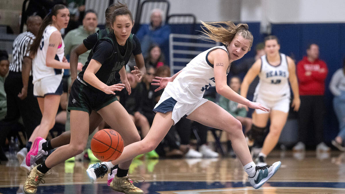 Emerald Ridge’s Naomi Senato (left) steals the ball from Olympia’s Brooke Juergens during Wednesday night’s 4A SPSL girls basketball game at Olympia High School in Olympia, Washington, on Jan. 24, 2024. Emerald Ridge won the game, 58-51.