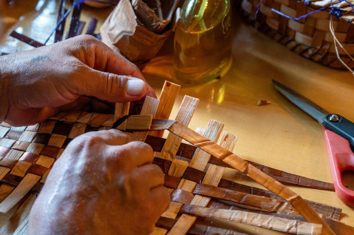 Hweqwidi Hanford McCloud, a Nisqually tribal member and a liaison for the Nisqually Tribal Council, demonstrates how he weaves hats using cedar bark on Friday, June 6, 2025, at the National Park Inn at Mount Rainier National Park.