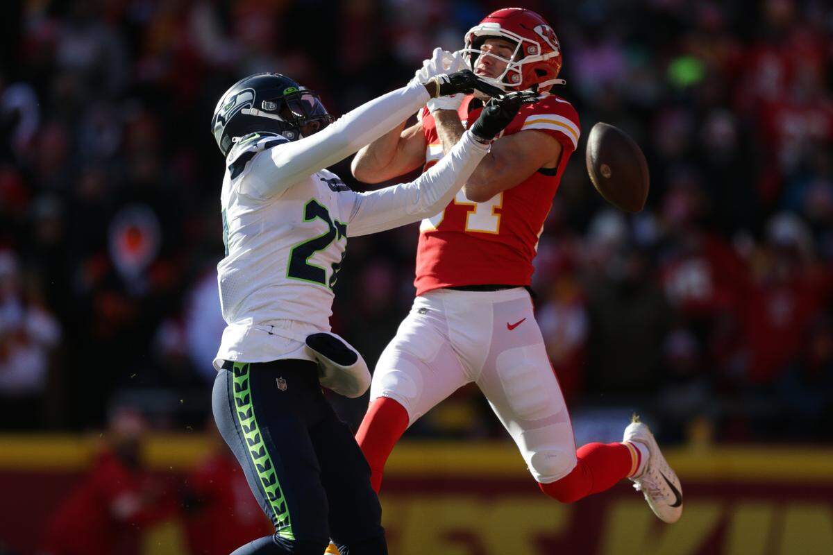 Seattle Seahawks cornerback Tariq Woolen (27) breaks up a pass intended for Kansas City Chiefs wide receiver Justin Watson (84) during the first quarter on Saturday, Dec. 24, 2022, in Kansas City, MO.