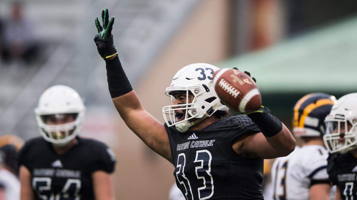 Eastside Catholic’s J.T. Tuimoloau celebrates a touchdown in the fourth quarter as the Bellevue Wolverines take on the Eastside Catholic Crusdaders during the state football semifinals at Pop Keeney Stadium in Bothell on Saturday, Nov. 24, 2018.