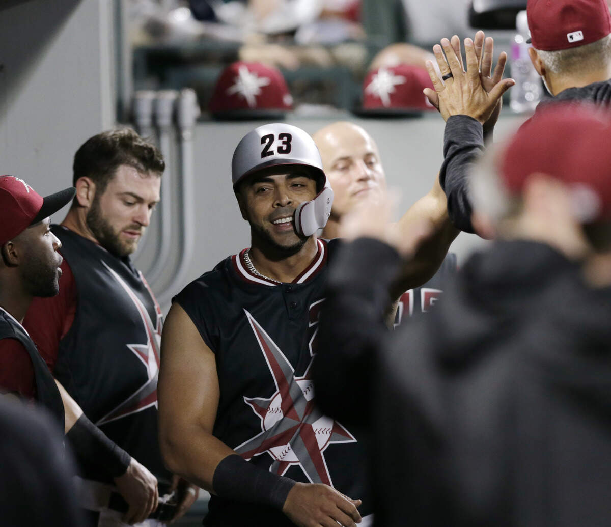 Seattle Mariners' Nelson Cruz makes his way through the dugout after scoring against the Kansas City Royals during the third inning of a baseball game Saturday, June 30, 2018, in Seattle. (AP Photo/John Froschauer)