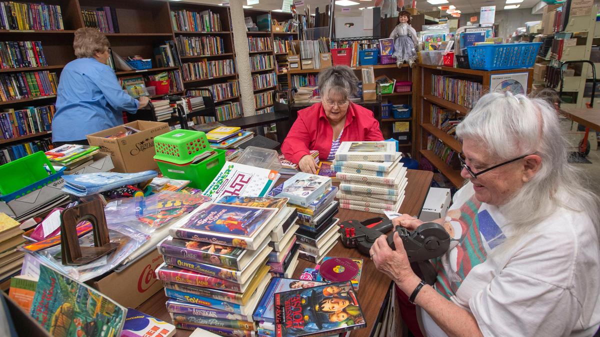 Friends of the Lakewood Library, affectionately nicknamed “moles” because they work in the basement, sort through donated materials in the children’s section in 2019. For decades the nonprofit’s volunteers have provided manpower for a running book sale that helps fund library programs. From right: Ginny Rawlings; Barbara Trimble; and Marsha Klaas.