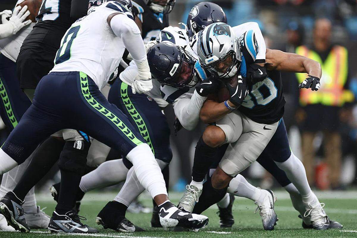 CHARLOTTE, NORTH CAROLINA - DECEMBER 28: Chuba Hubbard #30 of the Carolina Panthers fumbles as he is tackeled during the third quarter against the Seattle Seahawks at Bank of America Stadium on December 28, 2025 in Charlotte, North Carolina. (Photo by Jared C. Tilton/Getty Images)