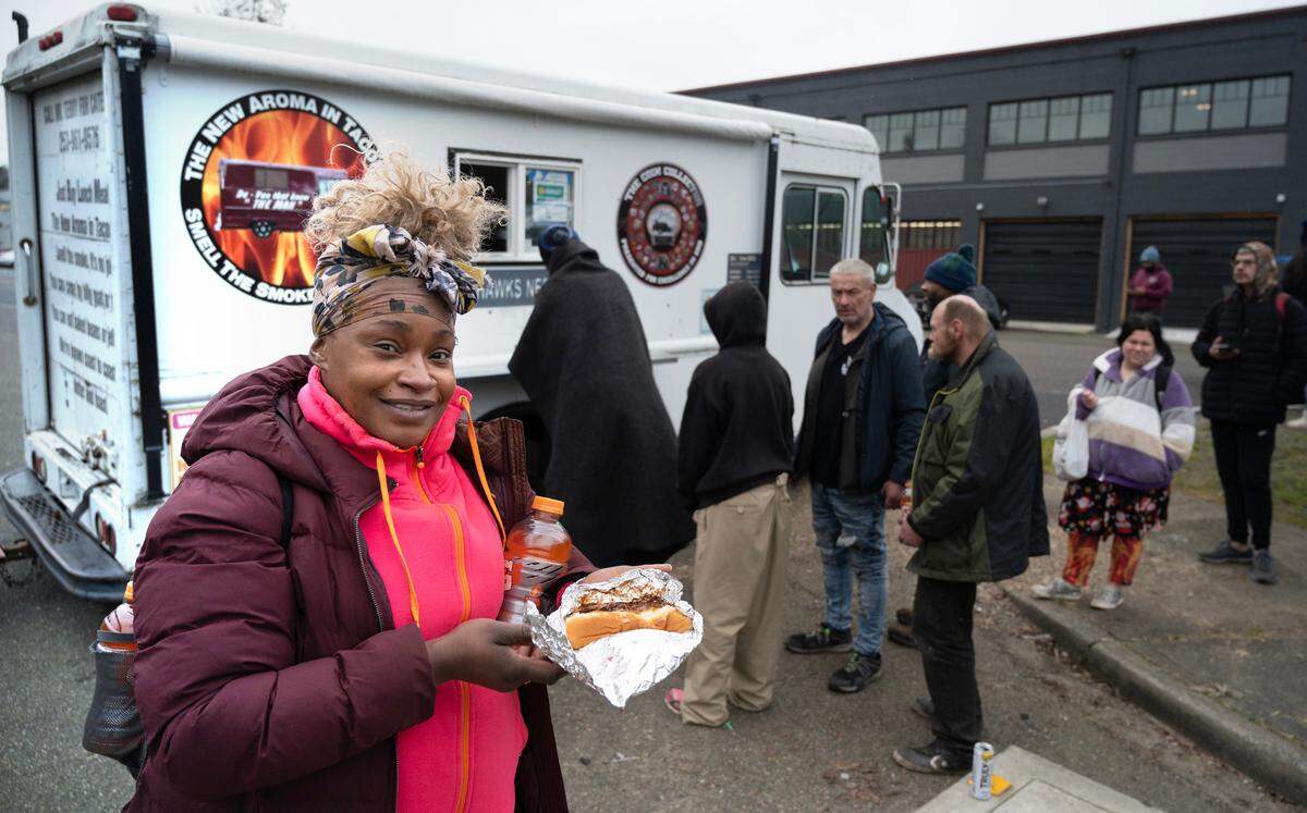 Homeless gather at “Mr. Terry” Hayes’ food truck as he serves up fresh jambalaya soup and bbq beef sandwiches in downtown Tacoma, Washington, on Monday, Feb. 5, 2023.