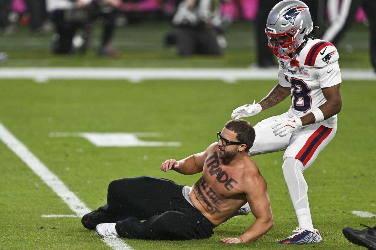 A shirtless fan runs on the field during Super Bowl LX at Levi’s Stadium in Santa Clara on Sunday, Feb. 8, 2026.