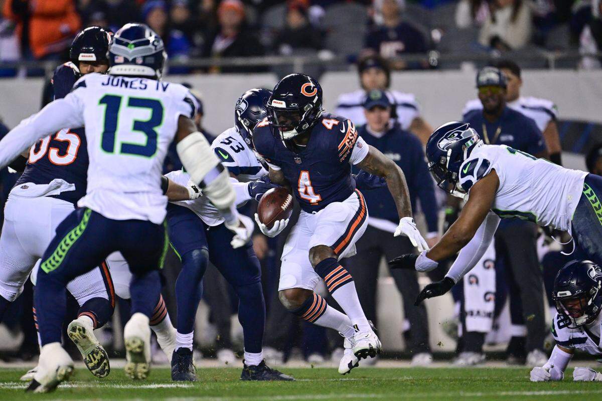 Dec 26, 2024; Chicago, Illinois, USA; Chicago Bears running back D'Andre Swift (4) runs after a catch against the Seattle Seahawks during the second quarter at Soldier Field. Mandatory Credit: Daniel Bartel-Imagn Images