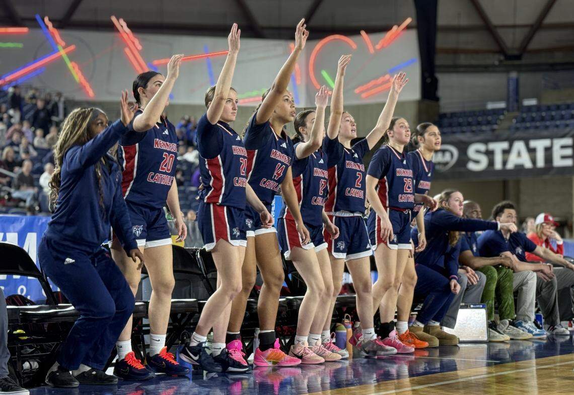 The Kennedy Catholic High School bench celebrates after a made shot during Kennedy Catholic’s upset win over No. 3 Chiawana in the opening round of the WIAA Class 3A high school girls basketball state tournament at the Tacoma Dome in Tacoma, Wash. on Wednesday, March 4, 2026.