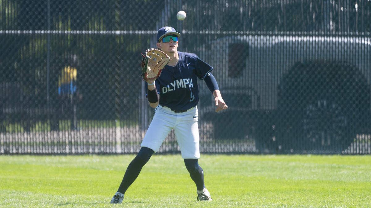 Olympia outfielder Lincoln Berg pulls in a fly ball during the 4A District 3/4 baseball semifinal game against the Tahoma Bears at Art Wright Field in Kent, Washington, on Saturday, May 11, 2024.