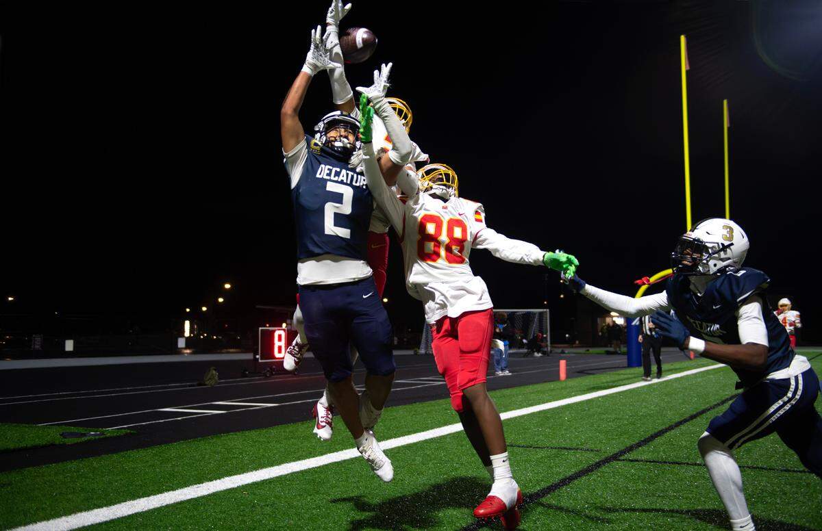Decatur’s Jasonni Prum (2) and Samuel Corbett (far right) battle Mount Tahoma defenders Anthony Quintanilla Jr. and Tyrone Walker (10) for a pass in the end zone during Friday night’s state football playoff game at Federal Way Memorial Stadium in Federal Way on Nov. 15, 2024. Mount Tahoma won the game, 23-21.